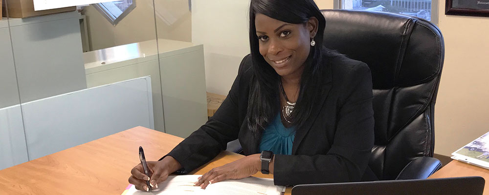 Akiesha, Manager of Project Accounting, working in her office Akiesha, Manager of Project Accounting, working in her office