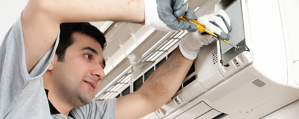 Man working on air conditioning unit